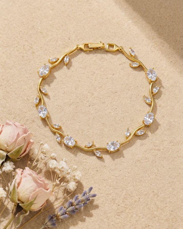 Gold bracelet with floral design on a beige background with flowers